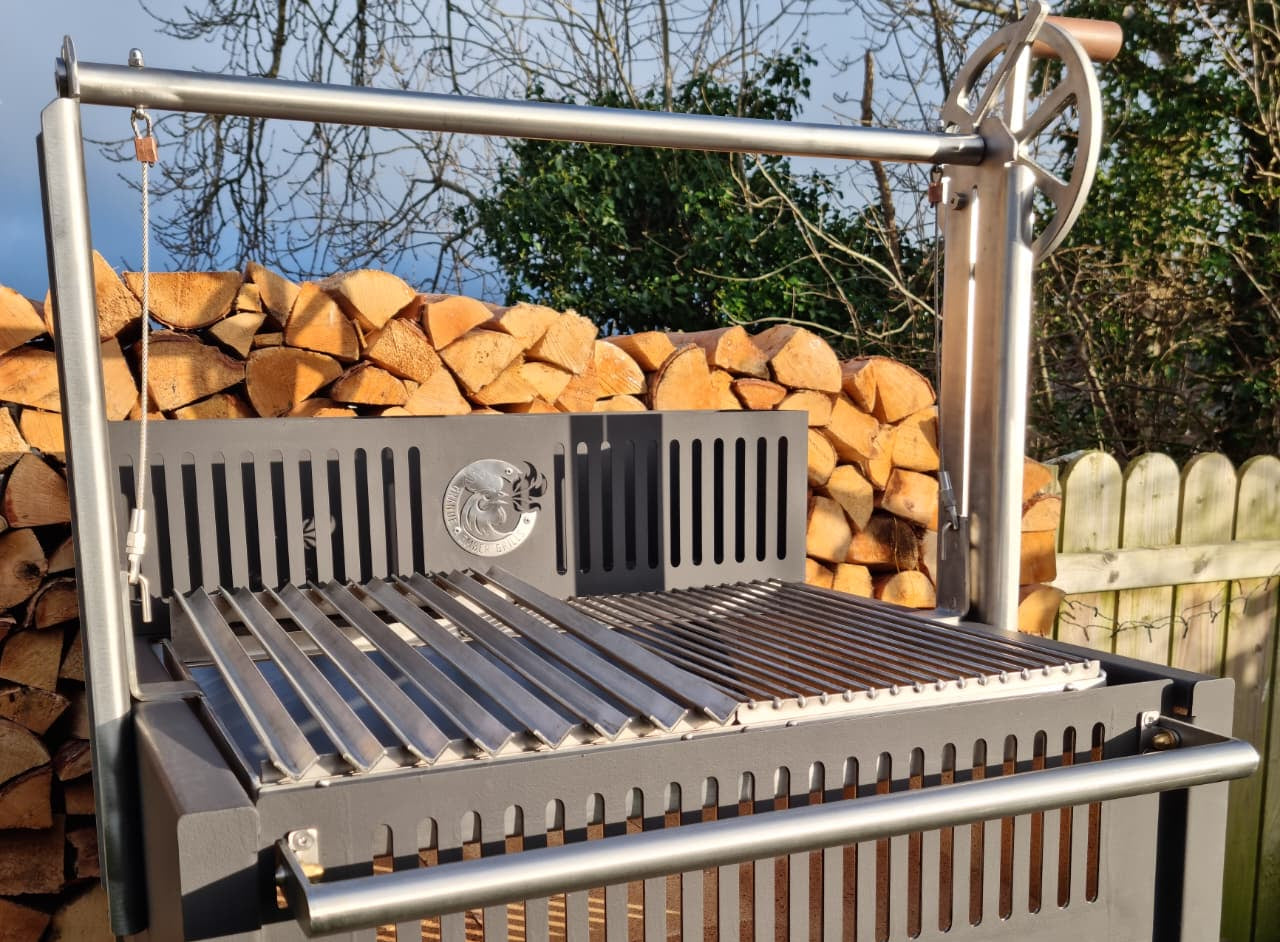 Argentinian grill with wooden logs stacked in the background