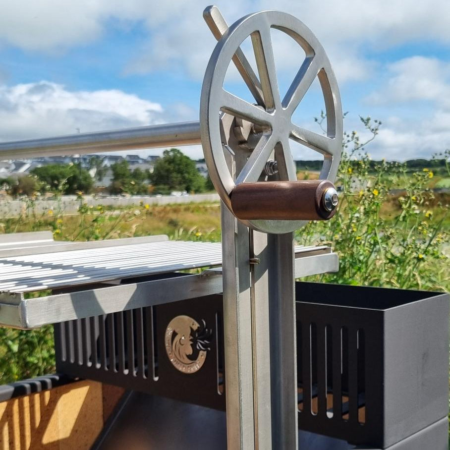 A stainless steel wheel with a wooden handle