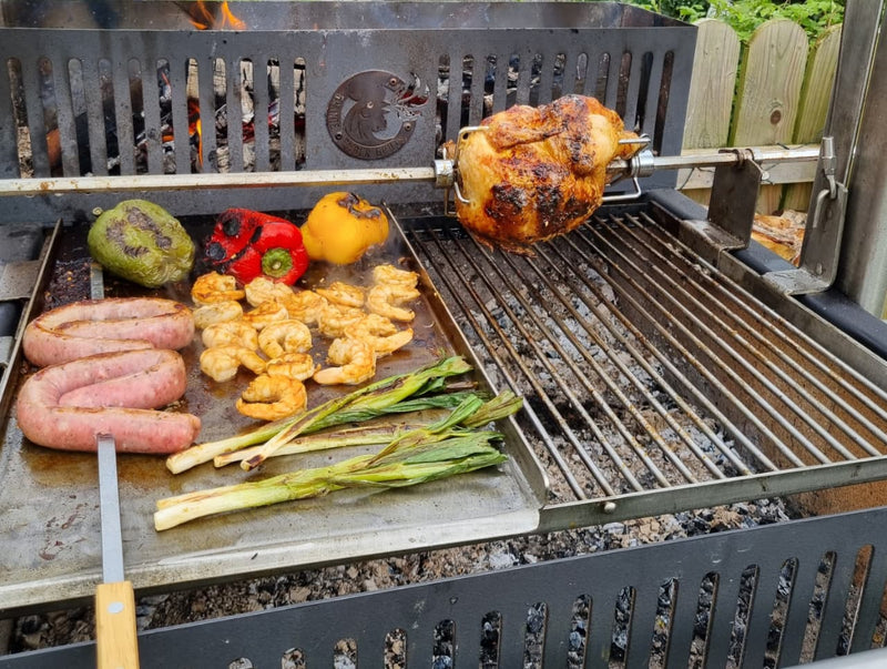 Argentinian grill with various meats and vegetables cooking on it