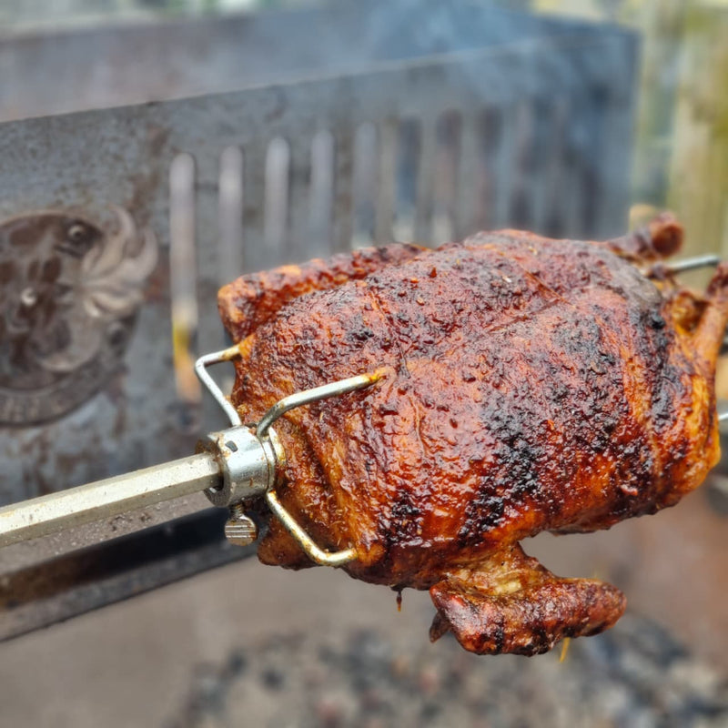 Rotisserie duck glazed to perfection over wood coals